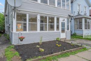 a house with a garden in front of it at 2-Bedroom Emerson Stay, Near Zoo, Museums and Downtown in Syracuse