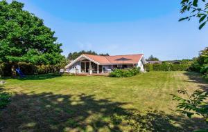 a house with a large yard in front of it at Awesome Home In Rudkøbing With Sauna in Spodsbjerg