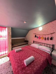 a bedroom with a red bed with two pillows on it at 5RoomsPansiyon in Edirne