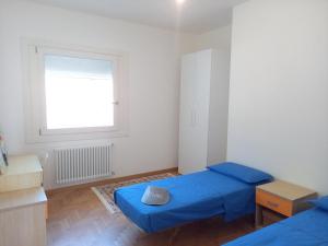a small room with two beds and a window at Luce del Mattino in San Vito al Tagliamento