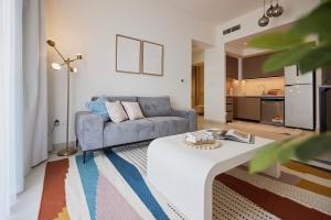 a living room with a couch and a table at Stylish 1BR Warm & Curated Interiors in Dubai