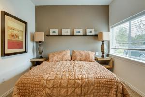 a bedroom with a bed with two lamps and a window at 11 Mi to Bear World Riverfront Getaway in Rigby in Rigby