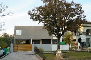 a house with a tree in front of it at La Maison Islamabad in Islamabad