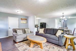 a living room with two couches and a table at 5 Mi to Dtwn Family-Friendly Fayetteville Home! in Fayetteville
