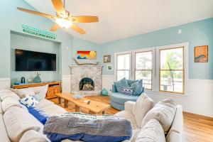 a living room with two couches and a fireplace at Hot Tub and Bay Views Outer Banks Home in Kill Devil Hills