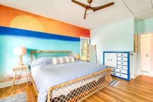 a bedroom with a bed and a blue wall at Hot Tub and Bay Views Outer Banks Home in Kill Devil Hills