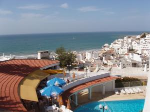 a view of a resort with a slide and the ocean at Apartamentos Tio Papel in Albufeira