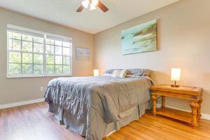 a bedroom with a bed and a table with two lamps at 6 Mi to Beach Port St Lucie Home with Fenced Yard in Eden