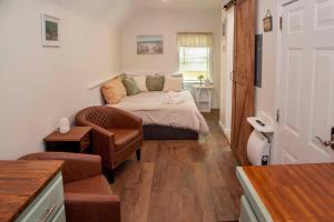 a small room with a bed and a chair at Lil Hickory in Hammondsport