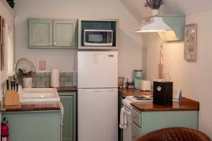 a kitchen with a white refrigerator and a microwave at Lil Hickory in Hammondsport +7 photos