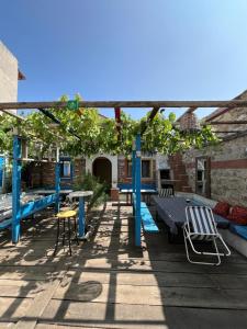 a pergola with tables and chairs on a deck at 5RoomsPansiyon in Edirne