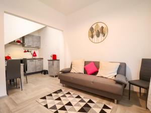 a living room with a couch and a kitchen at The Cozy Apartment - Wi-Fi, Smart TV, Free Parking in Montecatini Terme