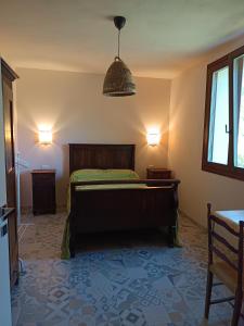 a bedroom with a bed and a pendant light at That's amore - l'incanto della valle 