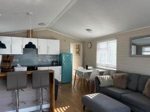 a kitchen and living room with a couch and a table at 43 Harbour View in Poole