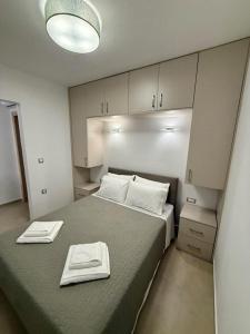 a bedroom with a bed with two towels on it at Charistella Apartment in Symi