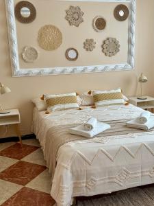 a bedroom with a large bed with towels on it at Ocean House in Ferrel