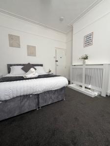 a bedroom with a large bed with white walls at Francis Avenue in Portsmouth