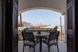 a table and chairs on a balcony with a view at Sempre Viva Apartment in Pylos
