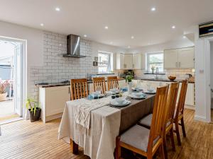 a kitchen and dining room with a table and chairs at 4 Bed in Combe Martin 83502 in Combe Martin