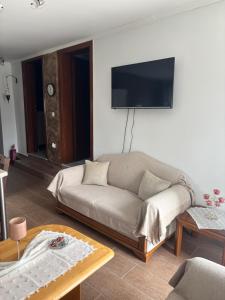 a living room with a couch and a flat screen tv at ΚΛΕΟΠΑΤΡΑ in Sfendámion