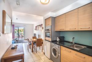 una cucina con armadi in legno e un tavolo con sala da pranzo di KÁ RICARDO - STUDIO 206 Vila Verde a Santa Maria