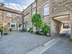a brick building with a parking lot in front of it at 2 Bed in Kirkby Lonsdale 95452 in Kirkby Lonsdale