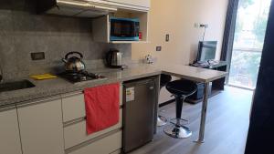 a kitchen with a sink and a stove top oven at Aparments Av La Paz in Arequipa +14 photos