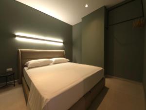 a bedroom with a bed with a light on it at Blue Harmony in Lalzit Bay