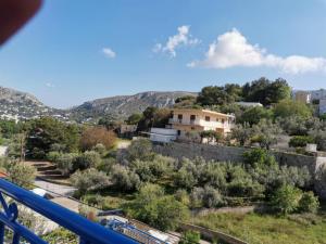 a view from the balcony of a house with trees at Valentino's Apartment 2 in Panormos Kalymnos