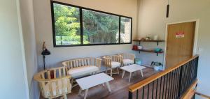 a room with chairs and a table and a window at Hygge Haus in Villa La Angostura