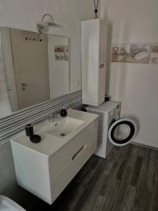 a bathroom with a sink and a toilet and a mirror at Ca' del Grillo in La Spezia