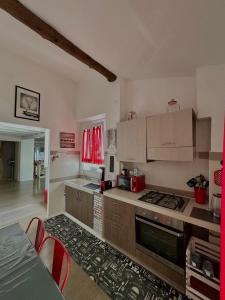 a kitchen with wooden cabinets and a stove top oven at Ca' del Grillo in La Spezia