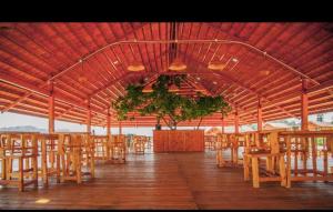 a group of tables and chairs in a pavilion at Hasini river side retreat in Hampi