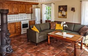 a living room with a couch and a table at Lovely Home In Lindesnes With Sauna in Svenevik