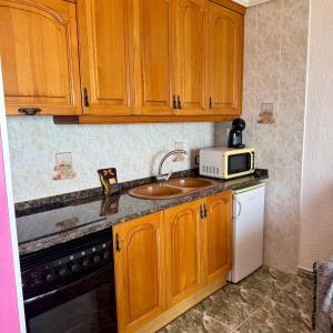 Kuchyň nebo kuchyňský kout v ubytování Apartamento Zodiac AB 6D