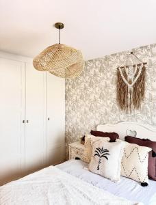 a bedroom with a white bed with a wall at Apartamento centro de Foz con piscina in Foz +24 photos