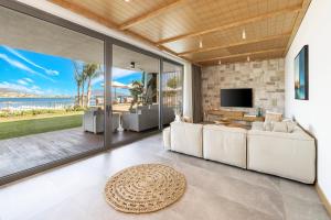 a living room with white couches and a tv at Mirada Exclusive Bodrum in Bodrum City
