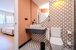 a bathroom with a sink and a mirror at ITC Madrid by Soho Boutique in Madrid