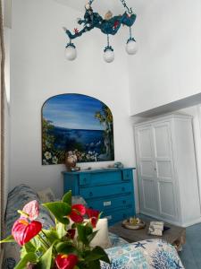 a room with a blue dresser and a mirror at La Bella Annacapri in Anacapri