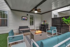 a patio with a couch and chairs and a fireplace at Rooftop Large Backyard Fire Pit Near Downtown Nashville in Nashville
