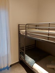 two bunk beds in a room with a window at Your Home near the beach - Sesimbra in Sesimbra +13 photos