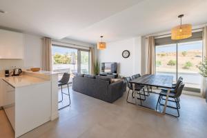 a kitchen and living room with a couch and a table at Ático Green Life by Solset in Vélez-Málaga
