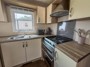 A kitchen or kitchenette at Stunning 8 Berth Caravan With Decking And Unlimited Wi-Fi, Ref 71012P