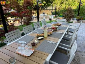 a long wooden table with chairs and food on it at Blaje in Breaza de Jos