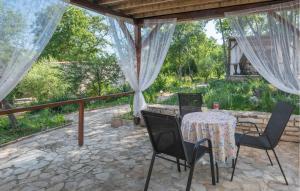 a patio with a table and chairs on a stone patio at Gorgeous Home In Rovinj With Wifi in Rovinj +21 photos