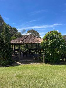 a gazebo in a park with two bushes at Casa de Campo, La Suiza in La Ceja, Antioquia in La Ceja +60 photos