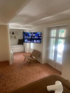 a room with a couch and a tv on the wall at Studio La Croisette Cannes La Croix d'Or 2 in Cannes