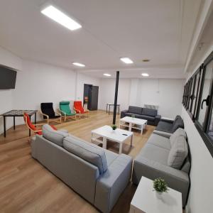 a living room with couches and tables at Miresileón in León +79 photos
