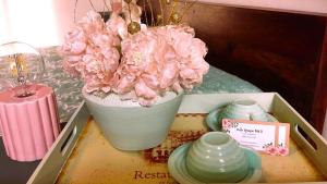 a vase filled with pink flowers sitting on a table at Belle Epoque B&B in Faenza