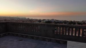 a view of a city from a balcony at sunset at Adem in Aïn El Turk
